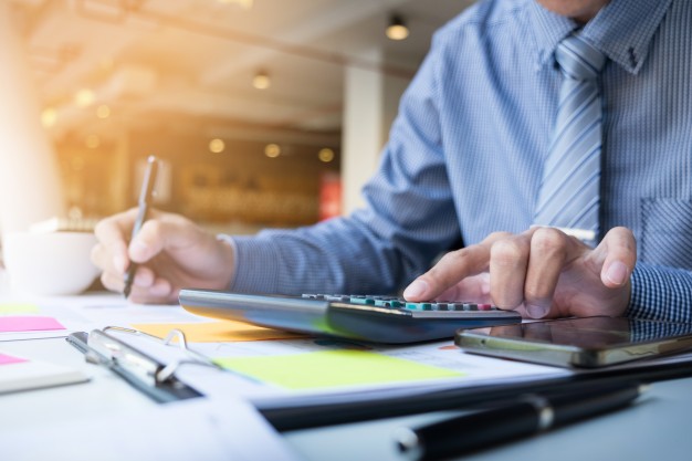 business-finance-man-calculating-budget-numbers-invoices-and-financial-adviser-working_1423-119